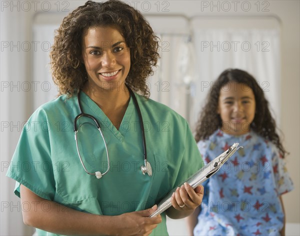 African female doctor holding chart