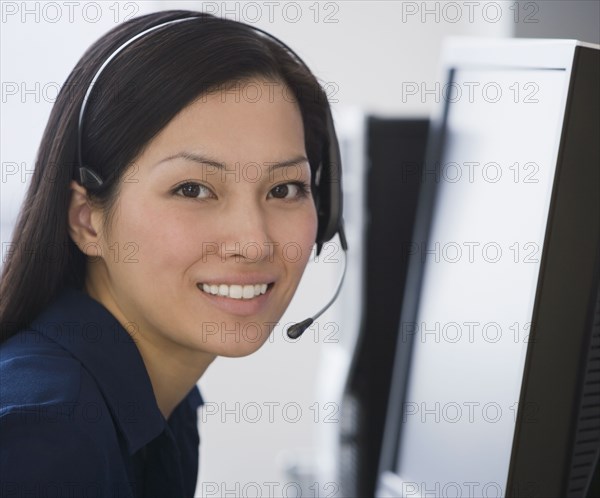 Asian businesswoman wearing headset