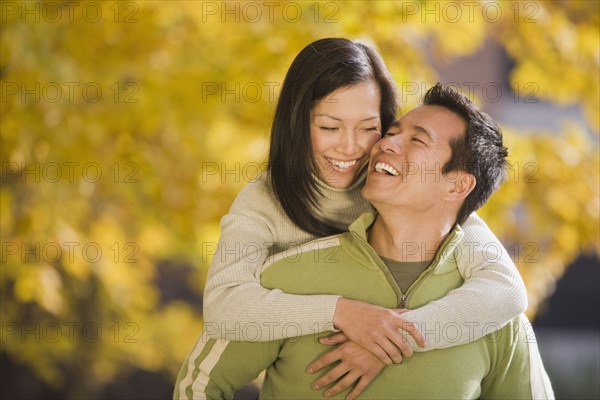 Asian woman hugging boyfriend