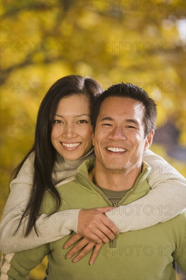 Asian woman hugging boyfriend