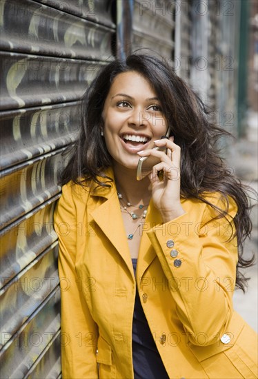 Mixed Race woman talking on cell phone