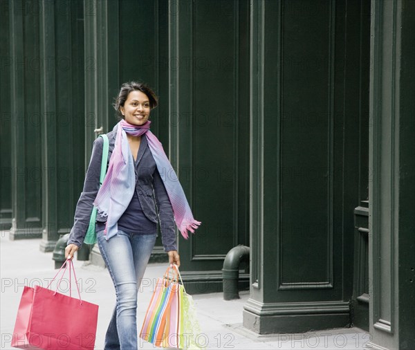 Mixed Race woman carrying shopping bags