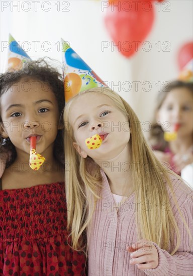 Multi-ethnic girls at birthday party