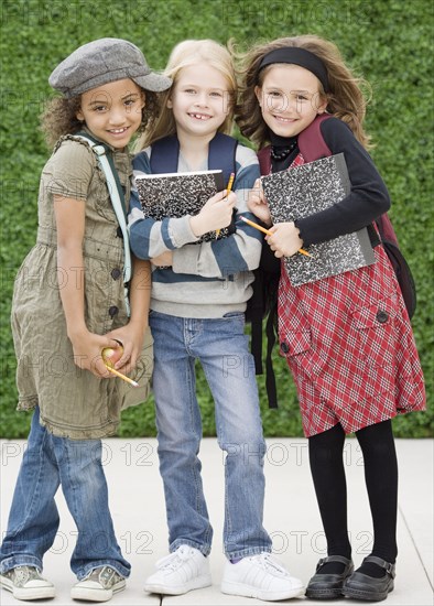 Multi-ethnic school girls on sidewalk