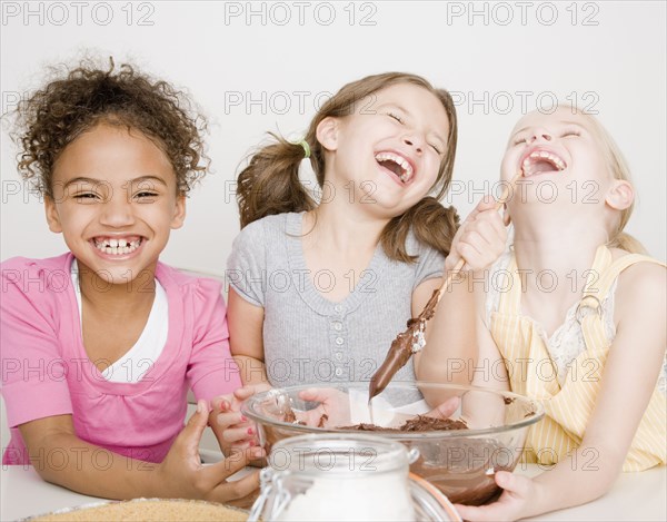 Multi-ethnic girls making batter