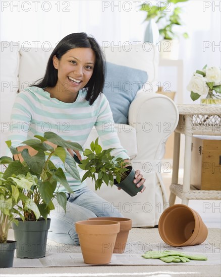 Pacific Islander woman re-potting plants