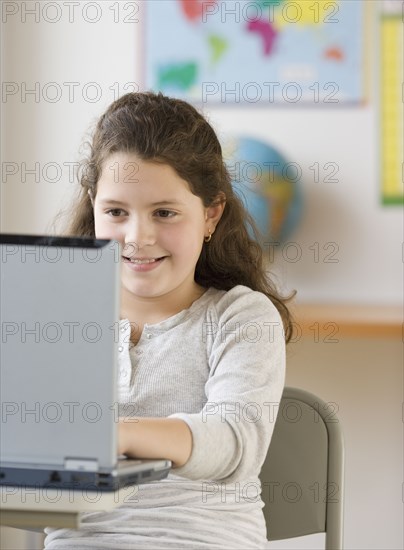 Hispanic girl looking at laptop