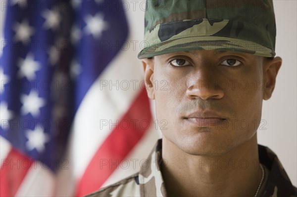 African male soldier in front of American flag