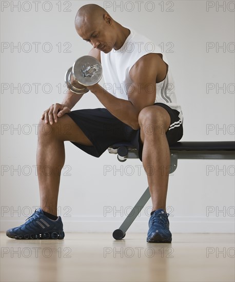 African man lifting dumbbell