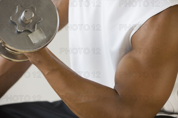 African man lifting dumbbell