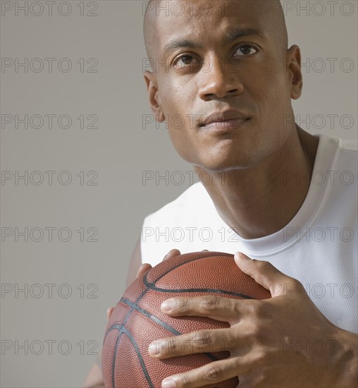 African man holding basketball