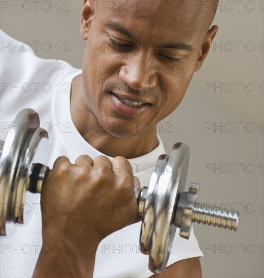 African man lifting dumbbell