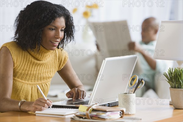 African woman looking at laptop