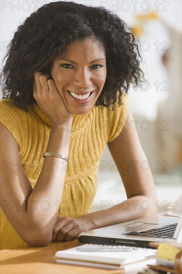 African woman next to laptop