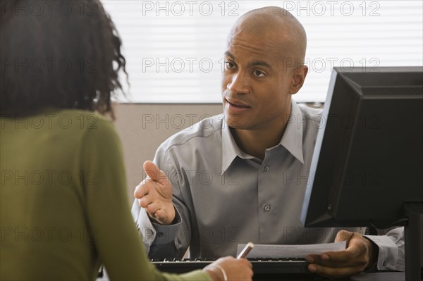 African businessman talking to co-worker