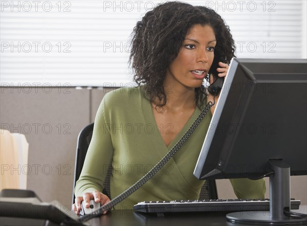 African businesswoman talking on telephone