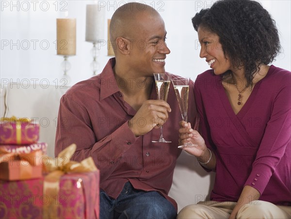 African couple toasting with champagne