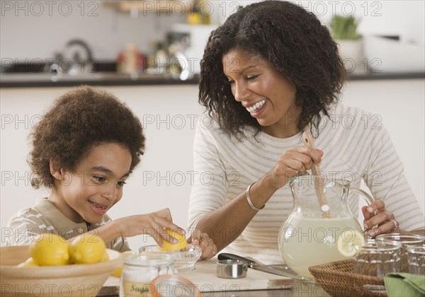 African mother and son making lemonade