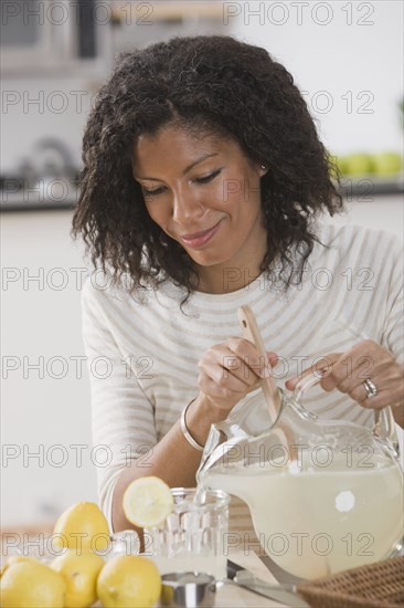 African woman pouring lemonade