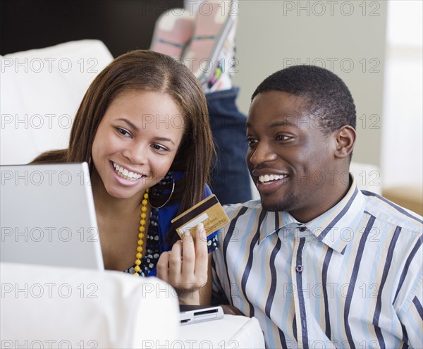 African couple shopping online