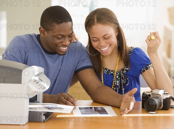 African couple printing out photographs