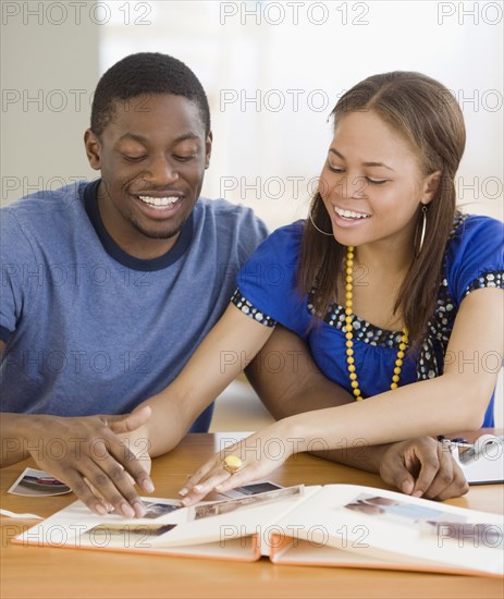 African couple making photo album