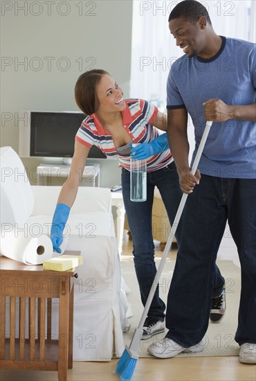 African couple cleaning house