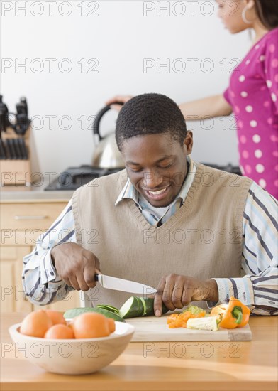 African man chopping vegetables