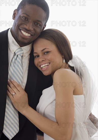 African newlyweds hugging