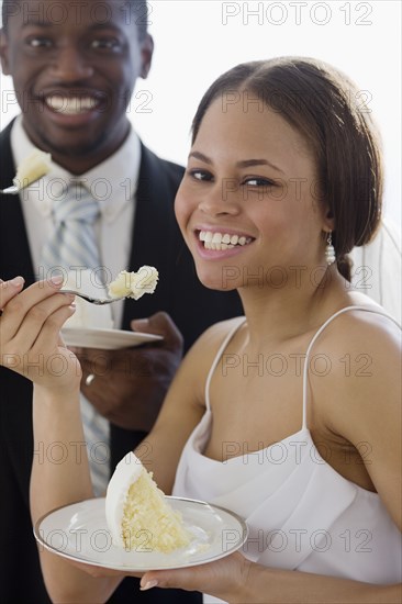 African newlyweds eating cake