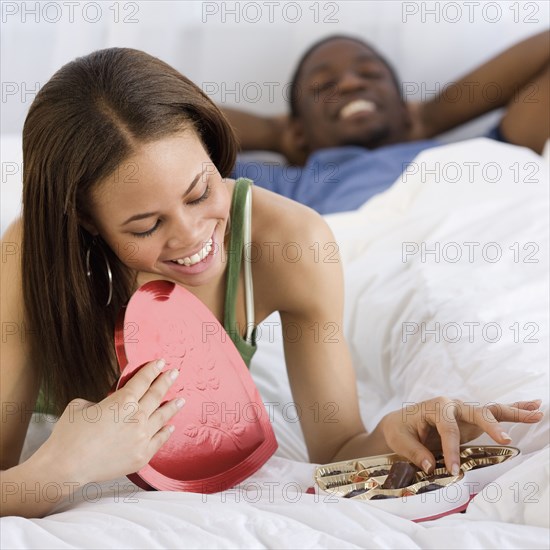 African woman eating valentine's day chocolate