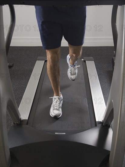 Hispanic man running on treadmill