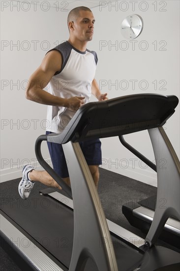 Hispanic man running on treadmill