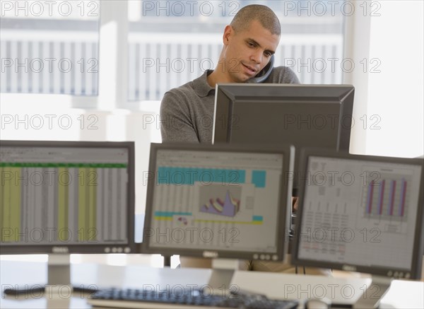 Hispanic businessman talking on telephone