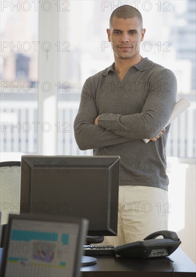 Hispanic businessman with arms crossed