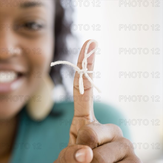 African woman with string tied around finger