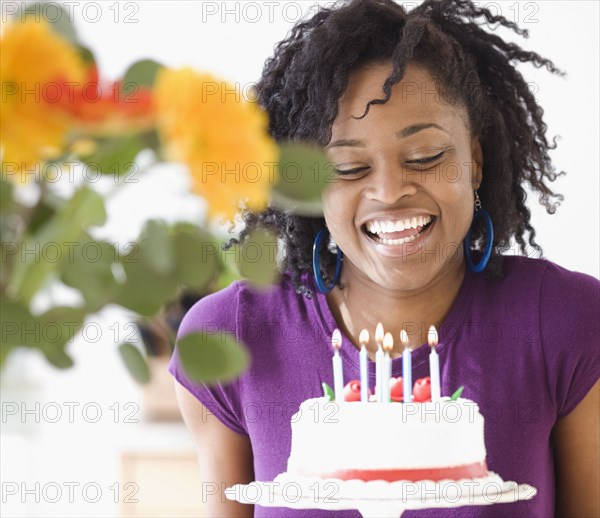 African next to birthday cake