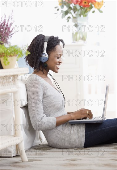 African woman typing on laptop