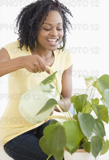 African woman watering plant