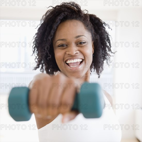 African woman holding free weight