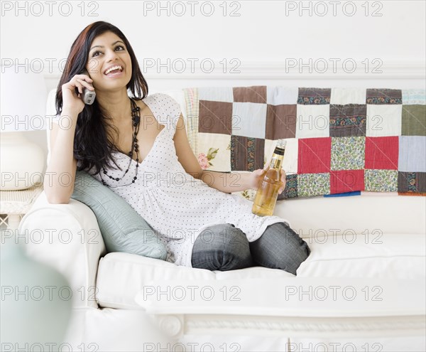 Mixed Race woman talking on telephone