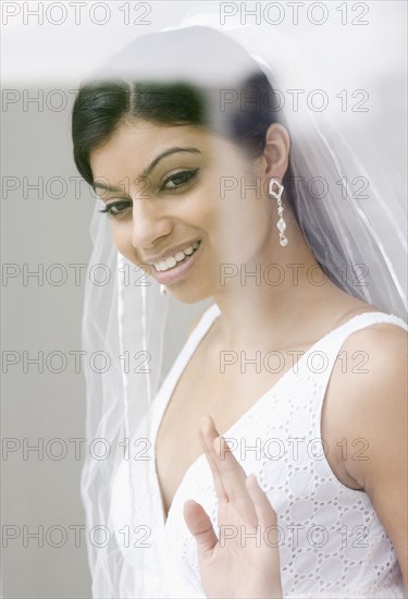 Mixed Race bride looking out window