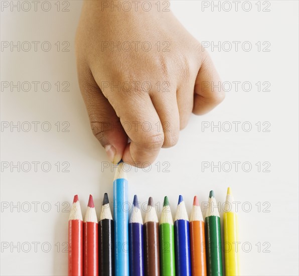 Close up of mixed race girl choosing colored pencil