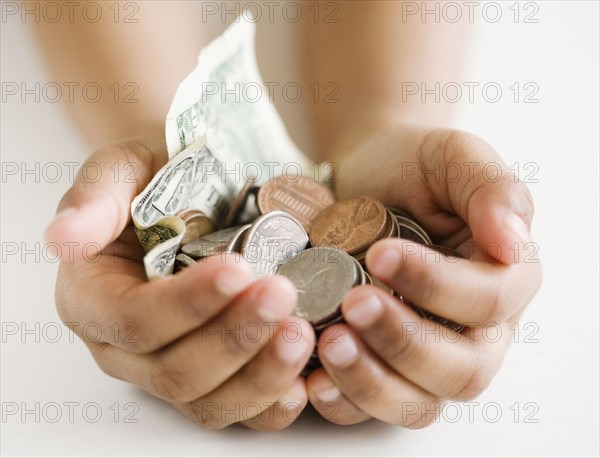 Close up of mixed race girl holding money