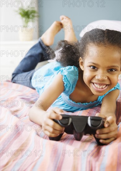 Mixed race girl playing video game