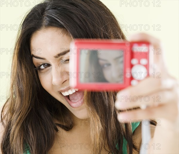 Middle Eastern woman taking self-portrait