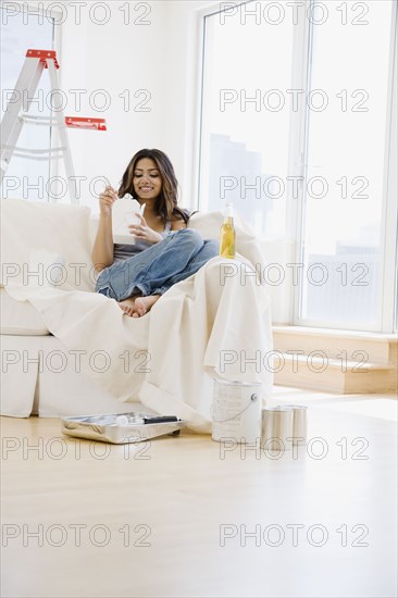 Middle Eastern woman eating Chinese take out