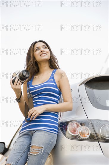 Middle Eastern woman holding camera