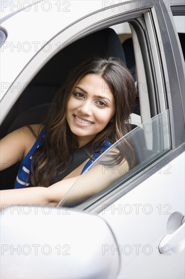 Middle Eastern woman driving car