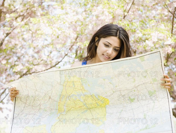 Middle Eastern woman holding map